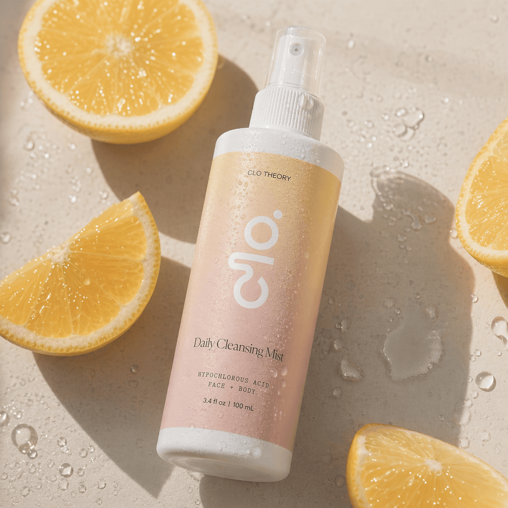 Clo Daily Cleansing Mist bottle among fresh lemon slices and water droplets