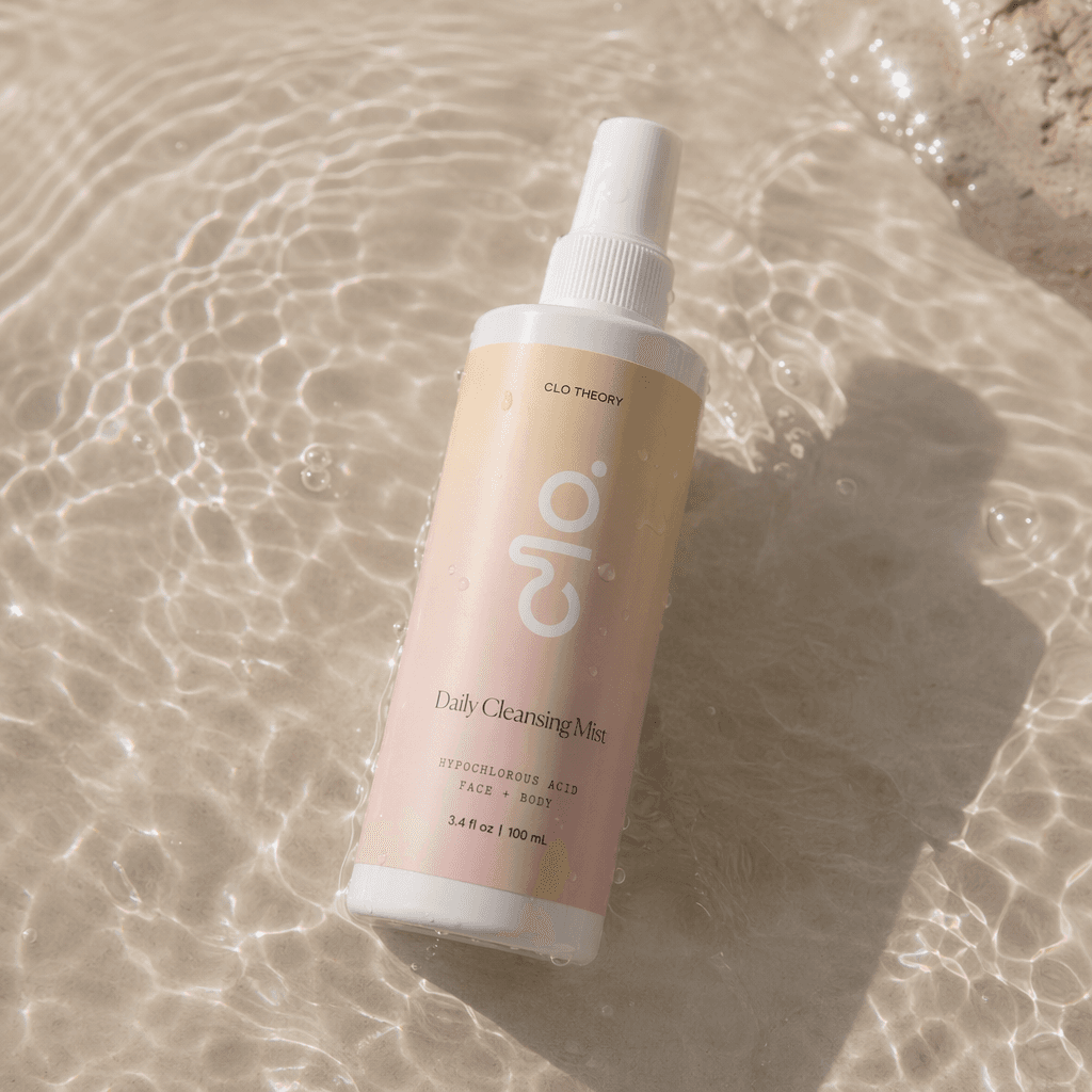 Clo Daily Cleansing Mist bottle resting in sunlit water