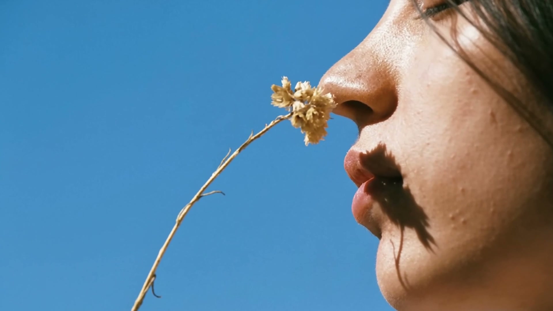 Skin against a clear blue sky